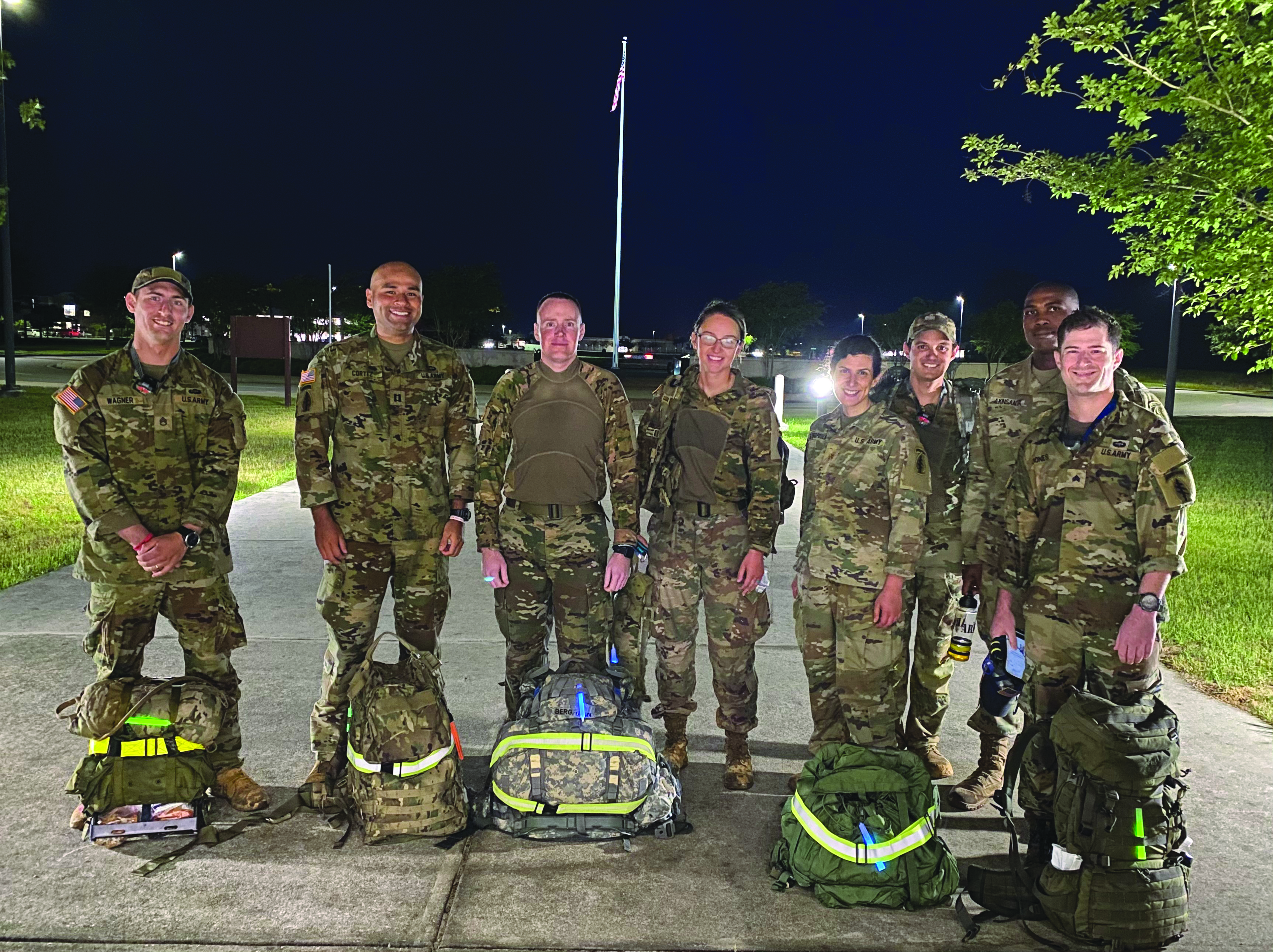 On 6 May 2021, between 0030 and 0500, members of the 7th Special Forces Group (Airborne) legal team successfully completed the 18.6-mile Norwegian Foot March at Camp “Bull” Simons, Eglin Air Force Base, Florida. Despite high humidity and miles of thick mud due to recent storms, the Red Empire’s judge advocates and paralegals lived the 7th SFG(A) motto of “Lo Que Sea, Cuando Sea, Donde Sea” (“Anything, Anytime, Anywhere”) and finished well under the required 4.5-hour limit. Pictured from left to right are an exhausted SSG Harry Wagner, CPT Ellis Cortez, MAJ Brandon Bergmann, CPT Christina Johnson, MAJ Atina Stavropoulos, SGT(P) Andrew Pena, CPT Tolulope Akinsanya, and SGT Nathan Jones.